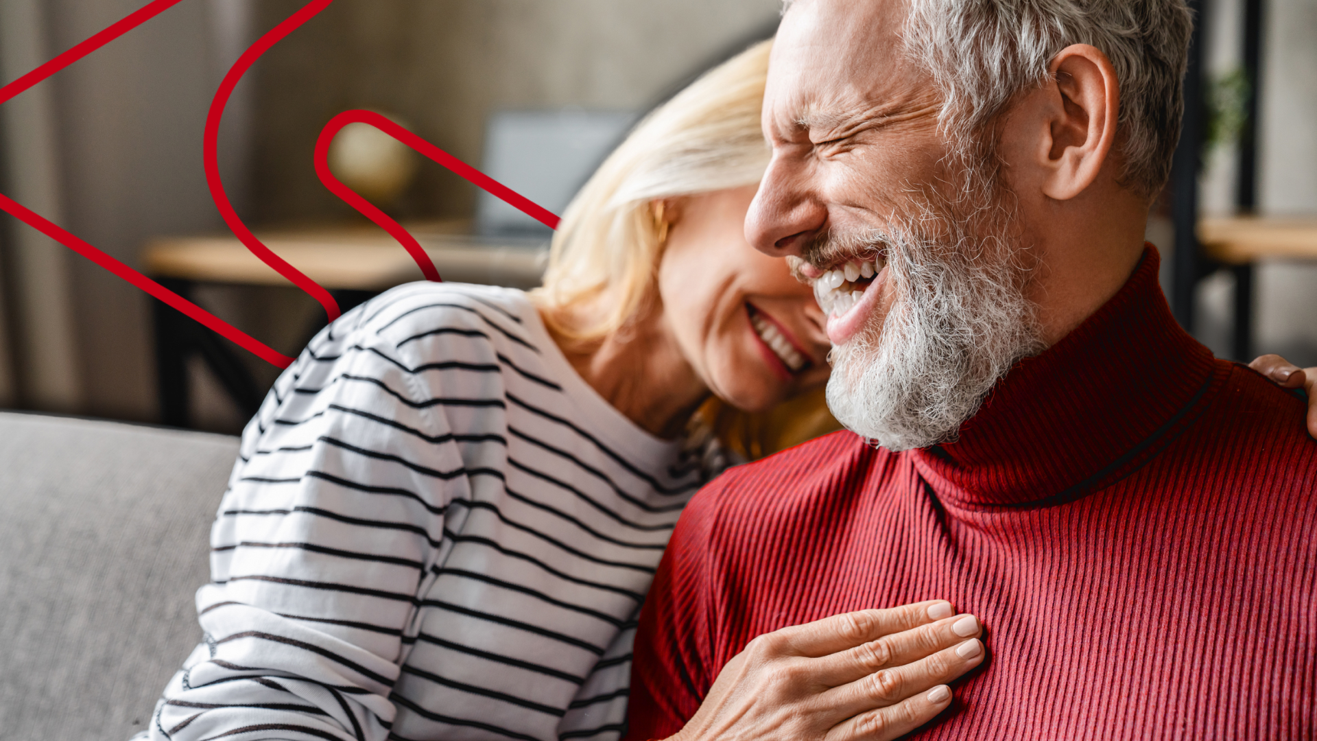 Middle age man and woman sitting together smiling. A Soarion emblem floats in the background.