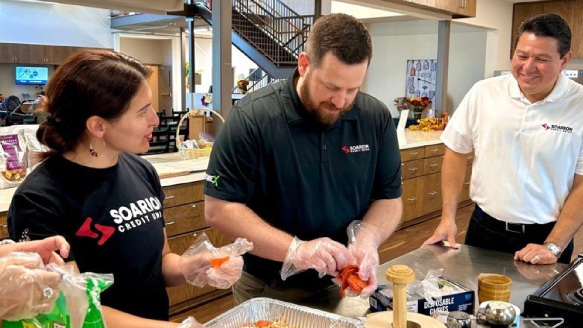 Group of Soarion employees prepare a meal at a local charity