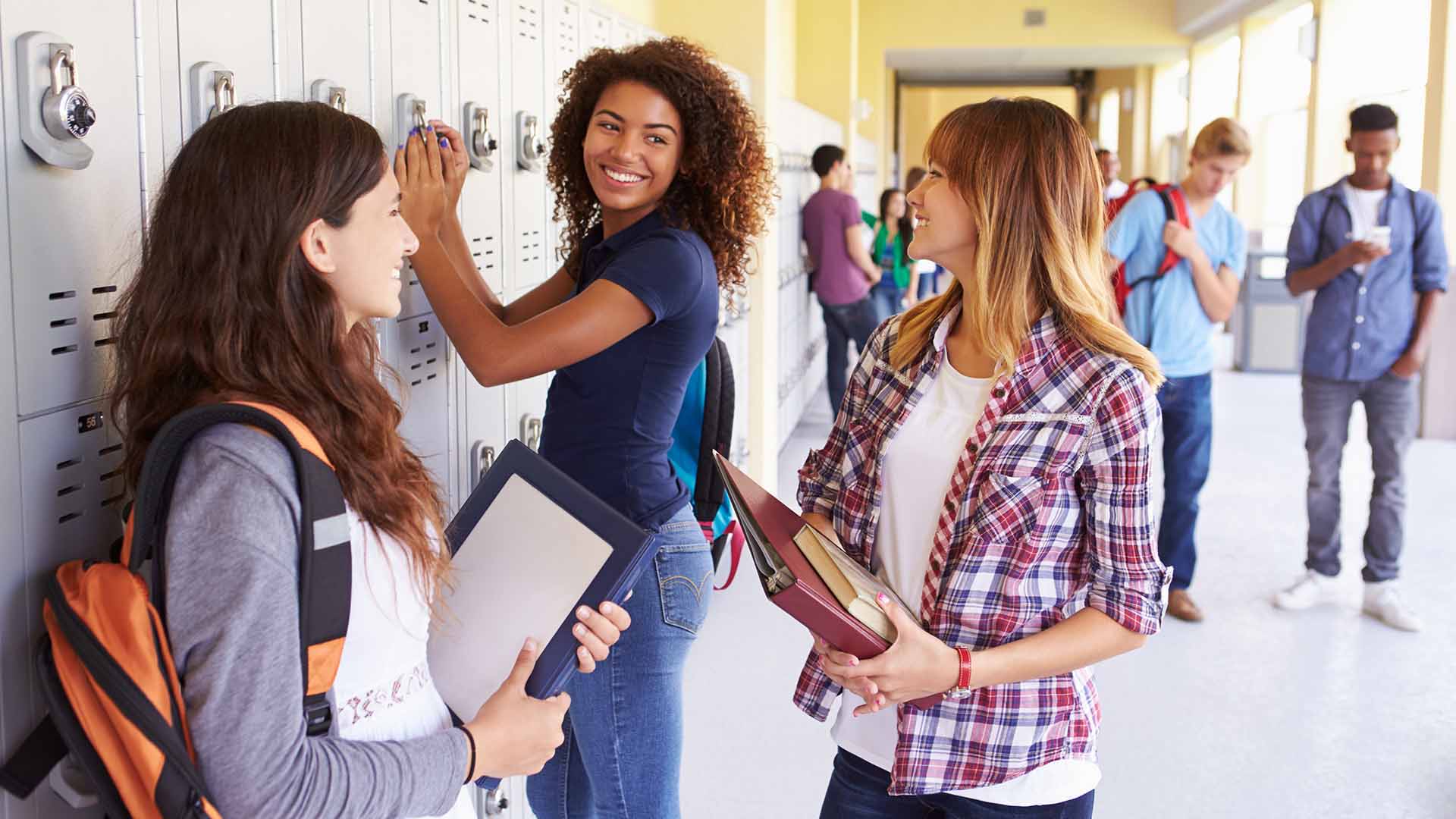 High school students hanging out by locker