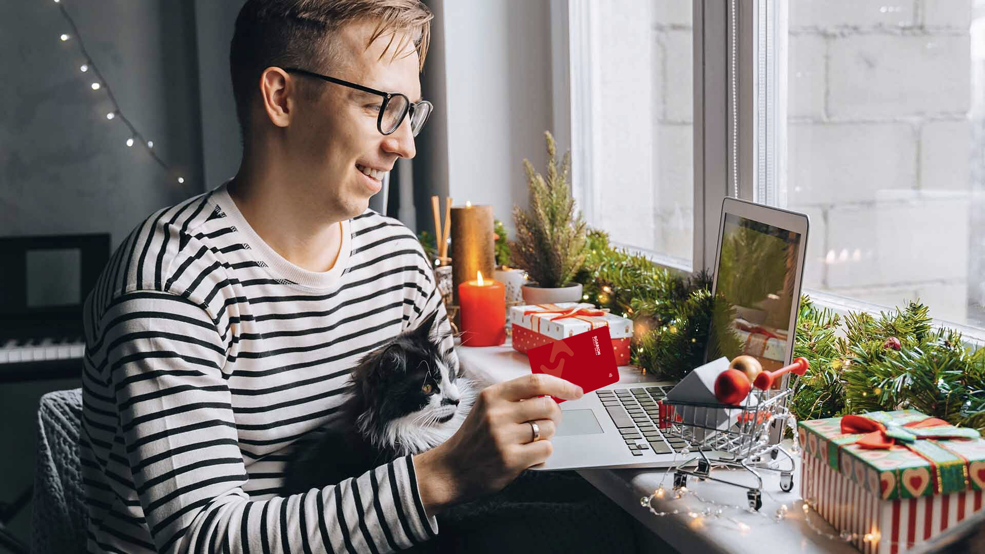 Man in striped shirt reviewing finances on laptop